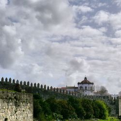 Buildings against cloudy sky