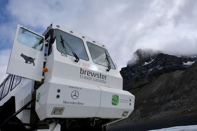 Low angle view of text on snow against sky