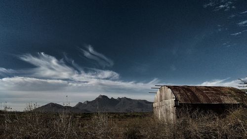 Houses on field against sky