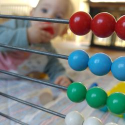 Close-up of abacus against baby at home