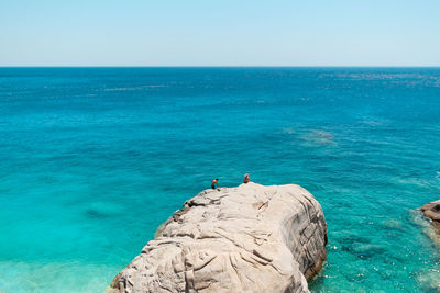 Scenic view of sea against clear blue sky