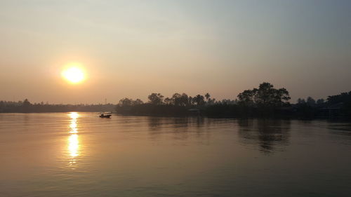 Scenic view of lake against sky during sunset