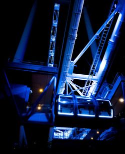 Low angle view of illuminated bridge at night