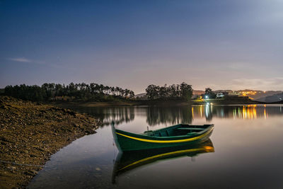 Scenic view of lake against sky at night