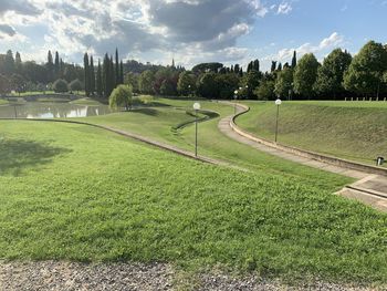 Scenic view of golf course against sky