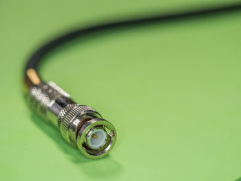 High angle view of network connection plug on green background