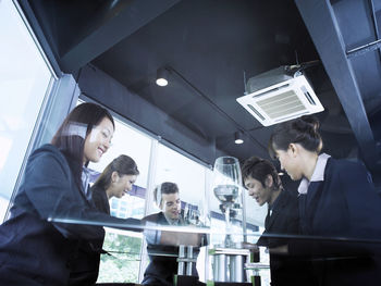 Colleagues with drinks at restaurant during meeting