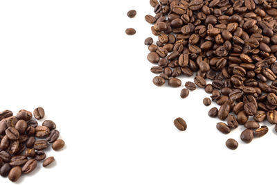 High angle view of coffee beans against white background