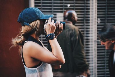 Rear view of woman photographing