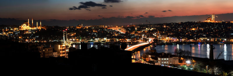 High angle view of illuminated buildings against sky at night