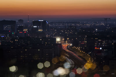 High angle view of illuminated buildings in city at night