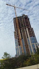 Low angle view of building against cloudy sky