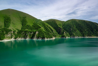 Scenic view of lake and mountains against sky