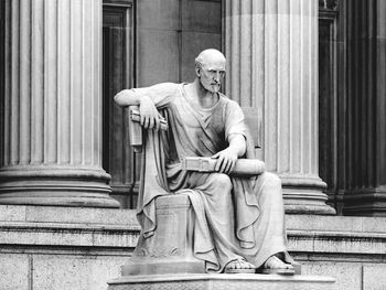 Statue of old man with book