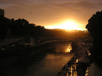 Bridge over river at sunset