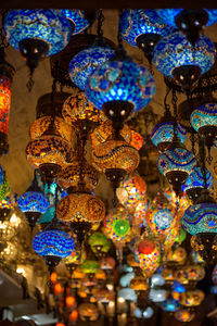 Low angle view of illuminated lanterns hanging at ceiling