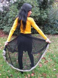 Woman wearing sunglasses against trees