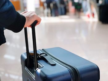 Close-up of man holding luggage 