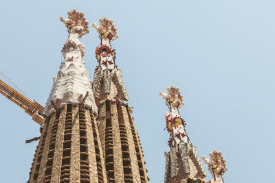 Low angle view of temple against building against clear sky