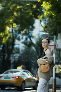 Side view of young woman holding bouquet