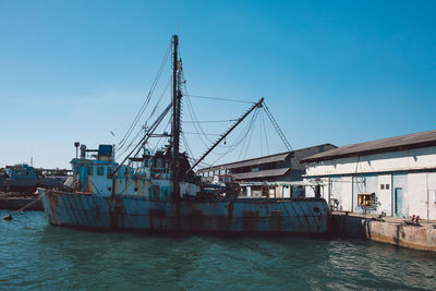 View of commercial dock against clear blue sky