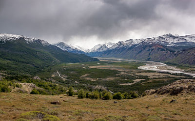 Scenic view of mountains against cloudy sky