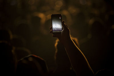 Hand with cell phone at concert