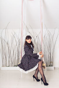 Portrait of young woman sitting outdoors