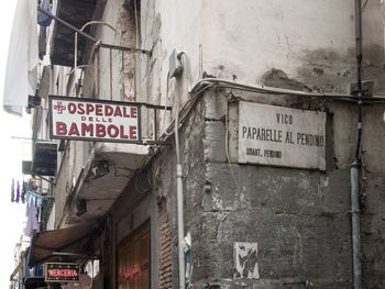 Low angle view of sign board against building