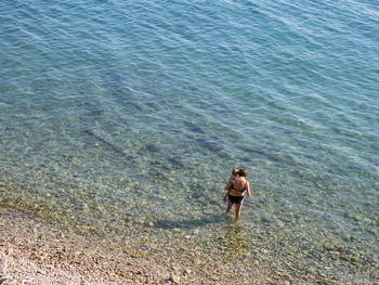 High angle view of friends standing on beach
