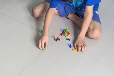 High angle view of boy playing with toy at home