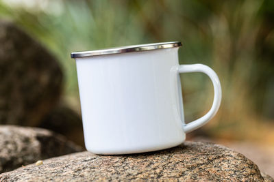 Close-up of coffee cup on rock