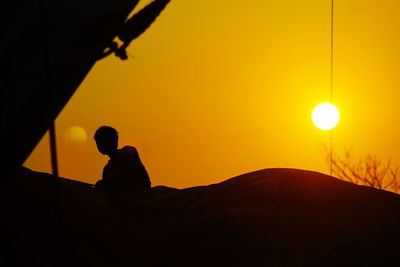 Low angle view of silhouette people against sky during sunset