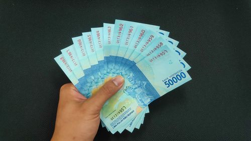 Midsection of person holding umbrella