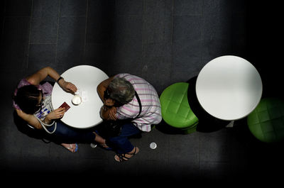 High angle view of man and woman sitting at table