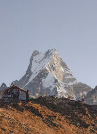 Scenic view of snowcapped mountains against clear sky