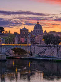 Bridge over river against sky during sunset