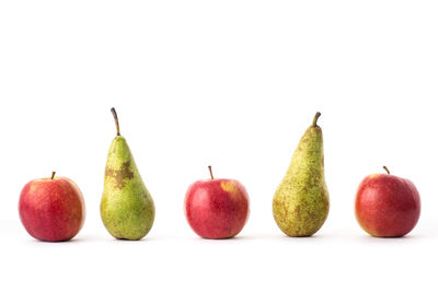 Close-up of apples and tomatoes against white background