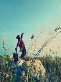 Man on field against clear sky