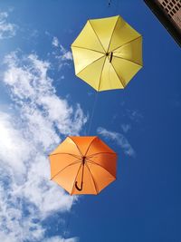 Low angle view of multi colored umbrella against sky