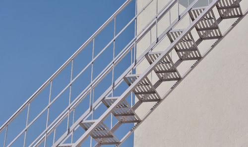 Low angle view of modern building against clear blue sky