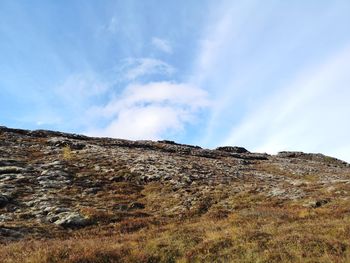 Low angle view of rocky mountain against sky