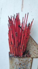 High angle view of red pencils on table against wall