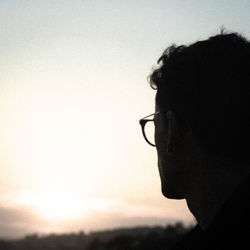 Close-up portrait of silhouette man against sky during sunset