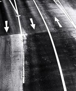 High angle view of road sign on wet street