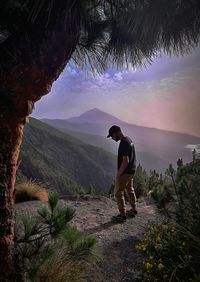 Man standing on mountain against sky