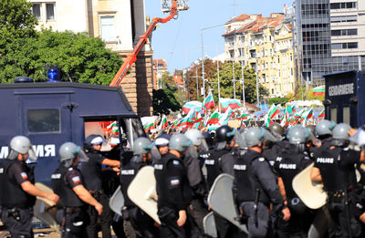 Police force controlling protestors on street