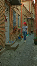 Rear view of woman walking on building