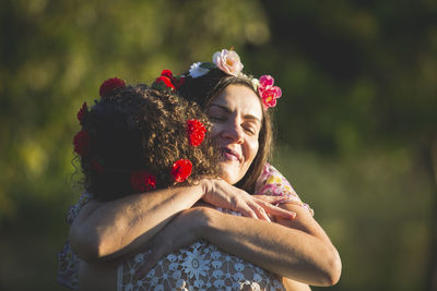 Rear view of women with red flower