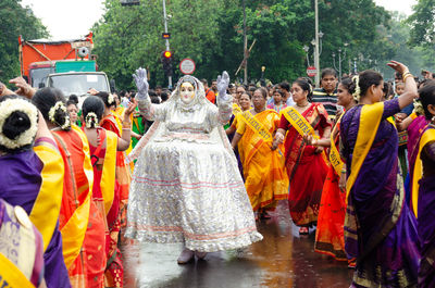 Rear view of people standing on street